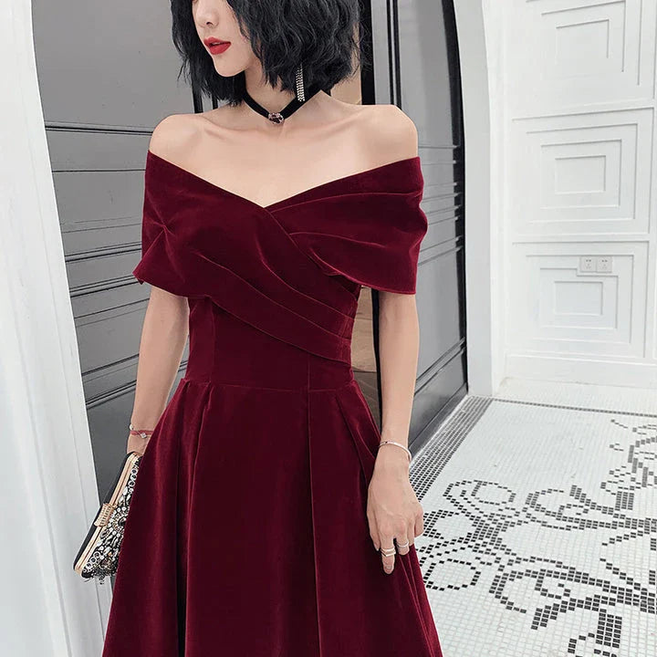 Off-shoulder wine red bridal dress with long, flowing skirt and tight waist for a sophisticated, elegant look