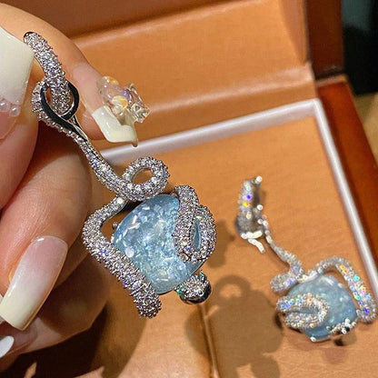 Sophisticated snake-inspired luxury earrings in a copper finish with inlaid gems and semi-precious stones