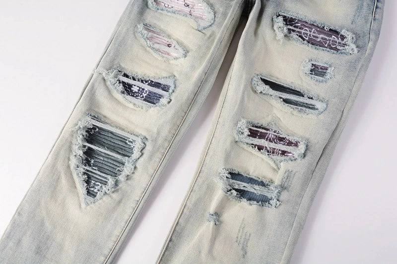 Stylish distressed denim jeans with a skinny, knee-exposed silhouette for a contemporary, high-street fashion look