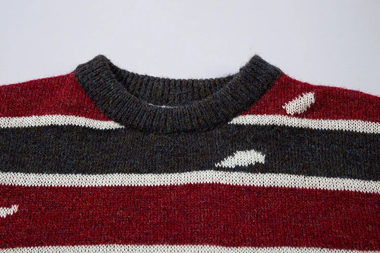 A cosy and stylish jumper featuring a patchwork design with contrasting stripes in a classic British colour palette.