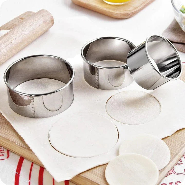 Premium stainless steel dumpling maker set with three distinct mold sizes for creating a variety of dumpling shapes