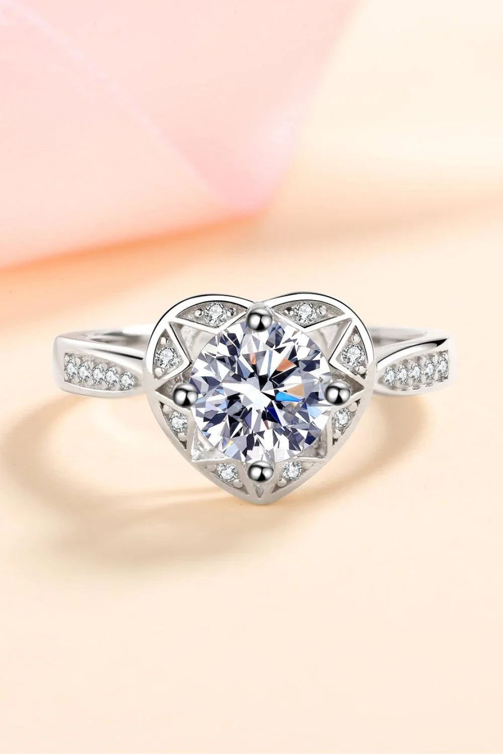 Elegant moissanite heart-shaped ring in sterling silver setting with zircon accent stones
