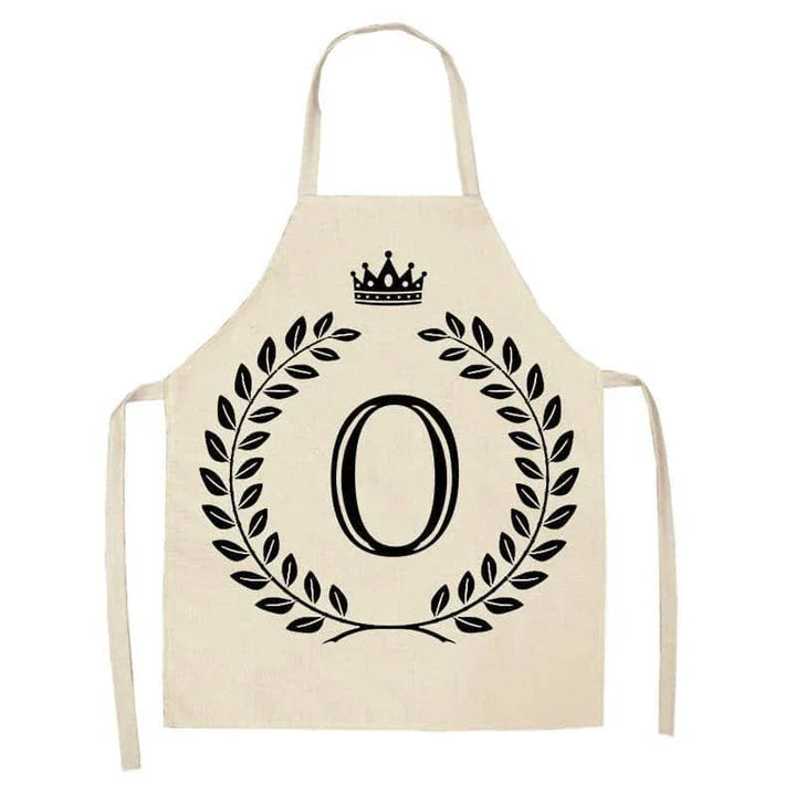 A high-quality kitchen apron featuring a charming crown and letter print design in a premium cotton and linen blend fabric.