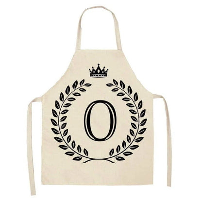 A high-quality kitchen apron featuring a charming crown and letter print design in a premium cotton and linen blend fabric.
