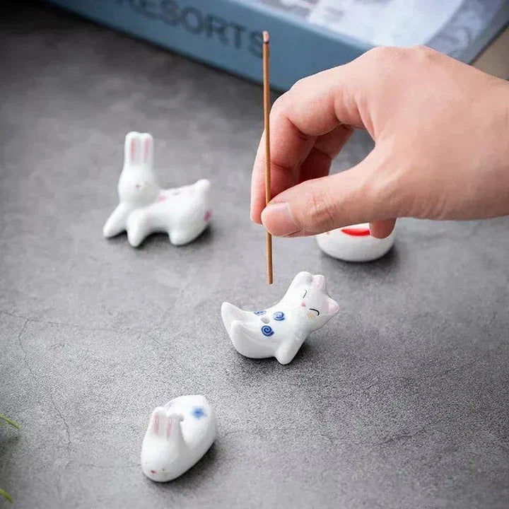 Charming Japanese-style ceramic incense holder with a playful rabbit and kitten design, perfect for creating a relaxing atmosphere in any room.