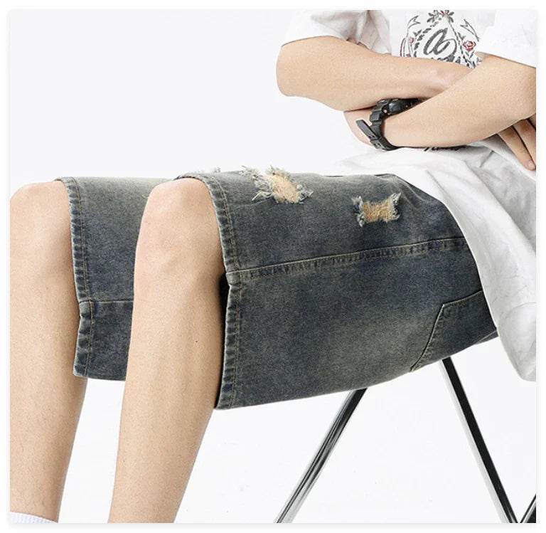 Premium British-crafted vintage-inspired ripped denim shorts for men with a straight-leg silhouette and authentic distressed details