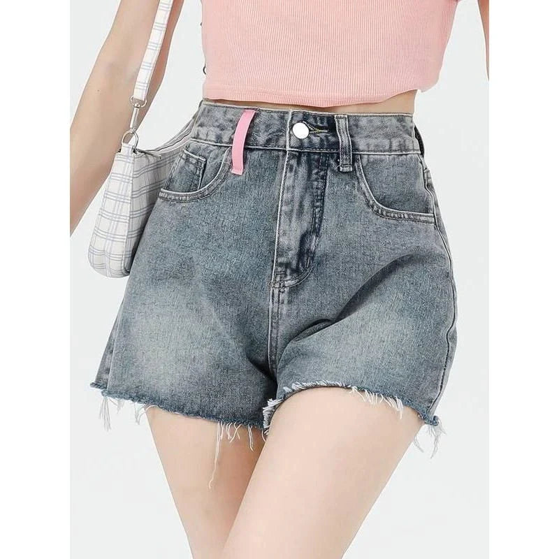 Stylish high-waisted denim shorts with subtle embroidery, perfect for summer fashion