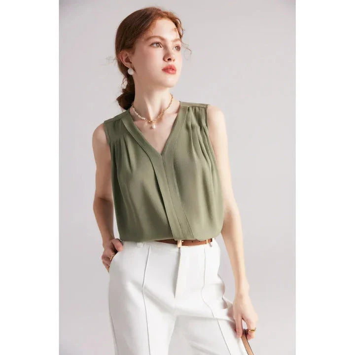 Elegant sleeveless silk blouse in a vibrant blue colour, designed for a sophisticated summer style