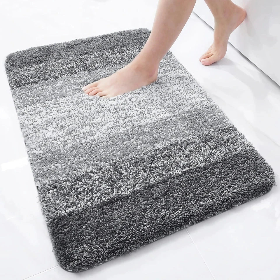 Luxurious microfibre absorbent bath mat with soft, plush texture and non-slip rubber backing for comfort and safety in the bathroom