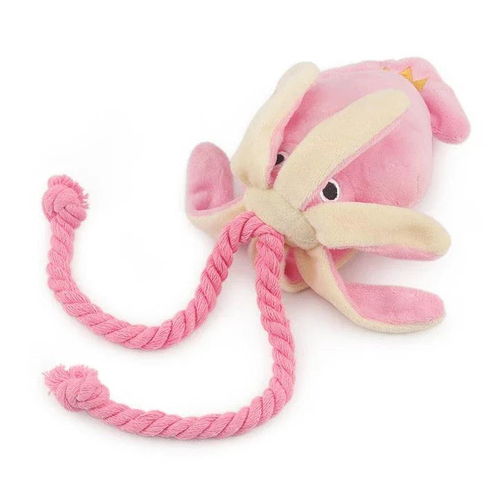 A soft, plush pink squid-shaped dog toy with a vibrant and whimsical design