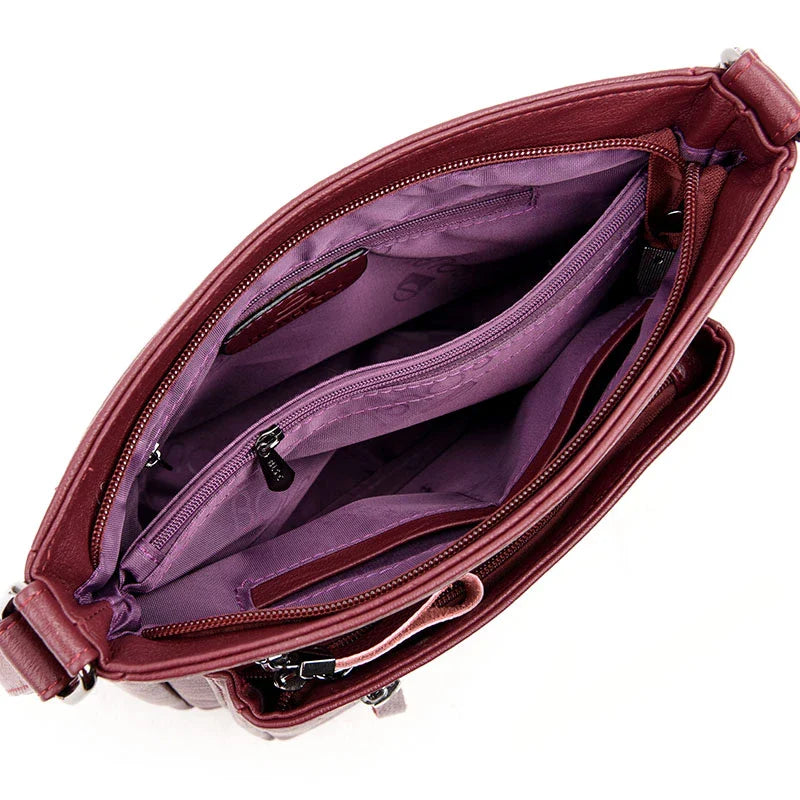 A stylish leather shoulder bag in a modern, box-style design, perfect for busy modern mums.