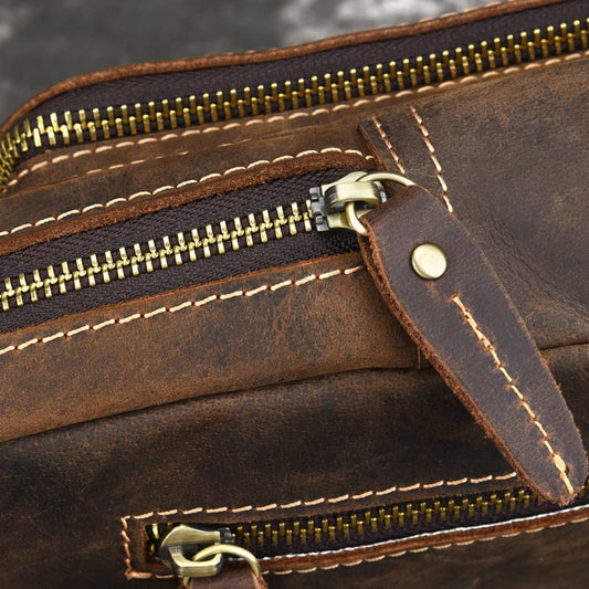 Vintage-inspired genuine leather briefcase with multiple compartments and secure zipper closure, ideal for modern commuters