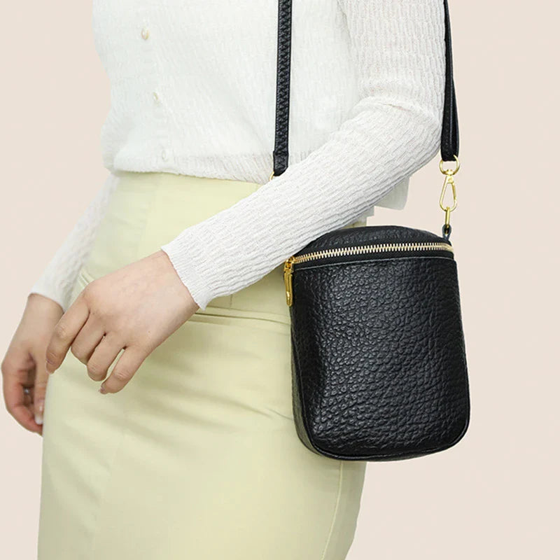 Elegant leather crossbody bag with adjustable strap, multiple pockets, and premium cowhide construction for the modern British woman