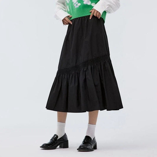 Elegant mid-length black skirt with an A-line silhouette, natural waistline, and unique irregular hemline, perfect for the modern British woman's wardrobe