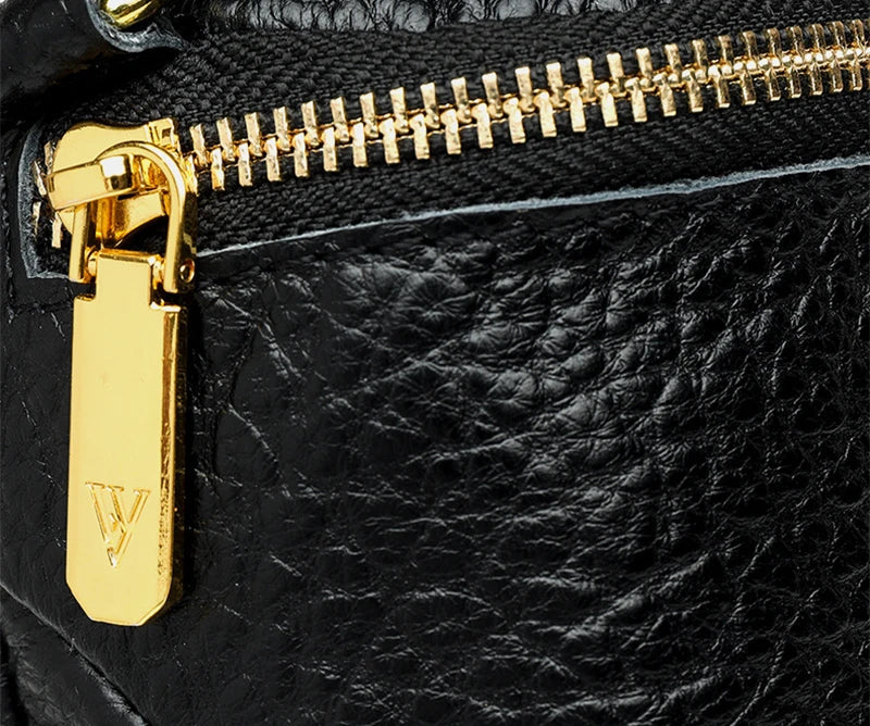 Elegant leather crossbody bag with adjustable strap, multiple pockets, and premium cowhide construction for the modern British woman