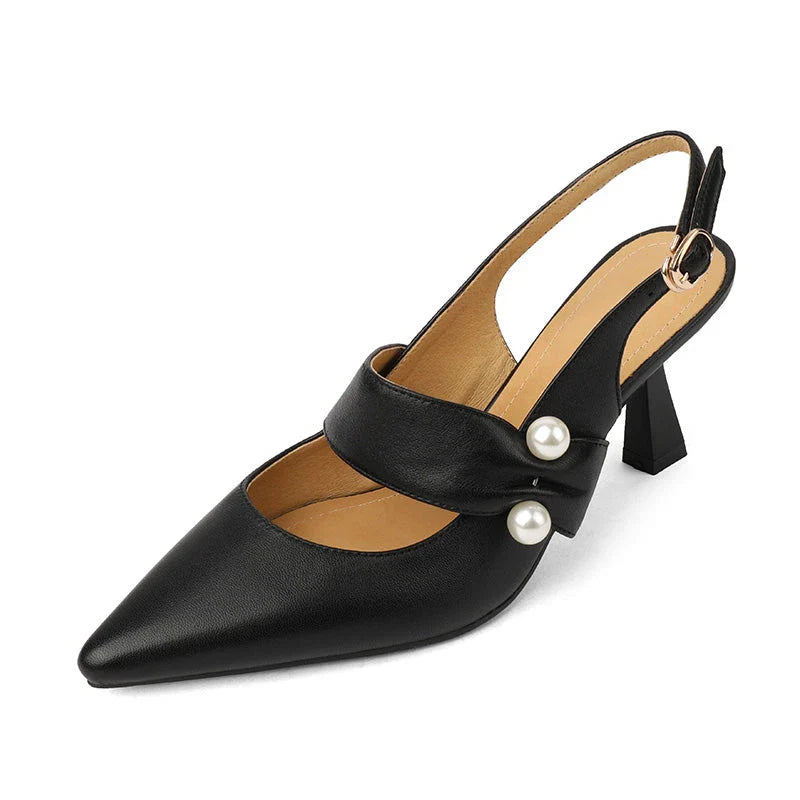 Pair of white high heel sandals with pearl embellishments, showcasing a unique and fashionable design