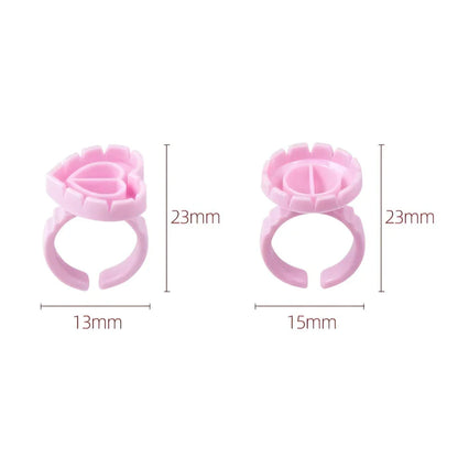 Heart-shaped disposable eyelash glue rings in blue, pink, and white colours