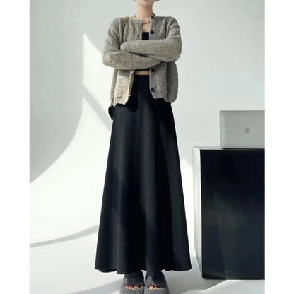 Elegant high-waist knitted skirt in black, showcasing a flattering A-line silhouette and ankle-length cut for the modern British woman.