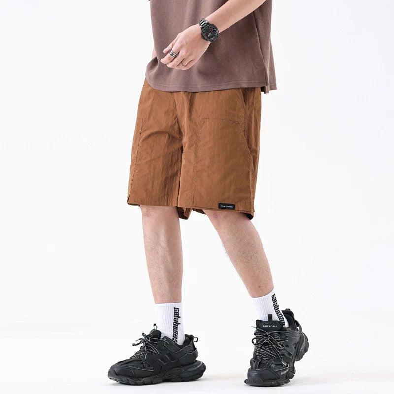 Premium men's quick-drying casual trousers in black, caramel, and sand colours with a relaxed, loose fit