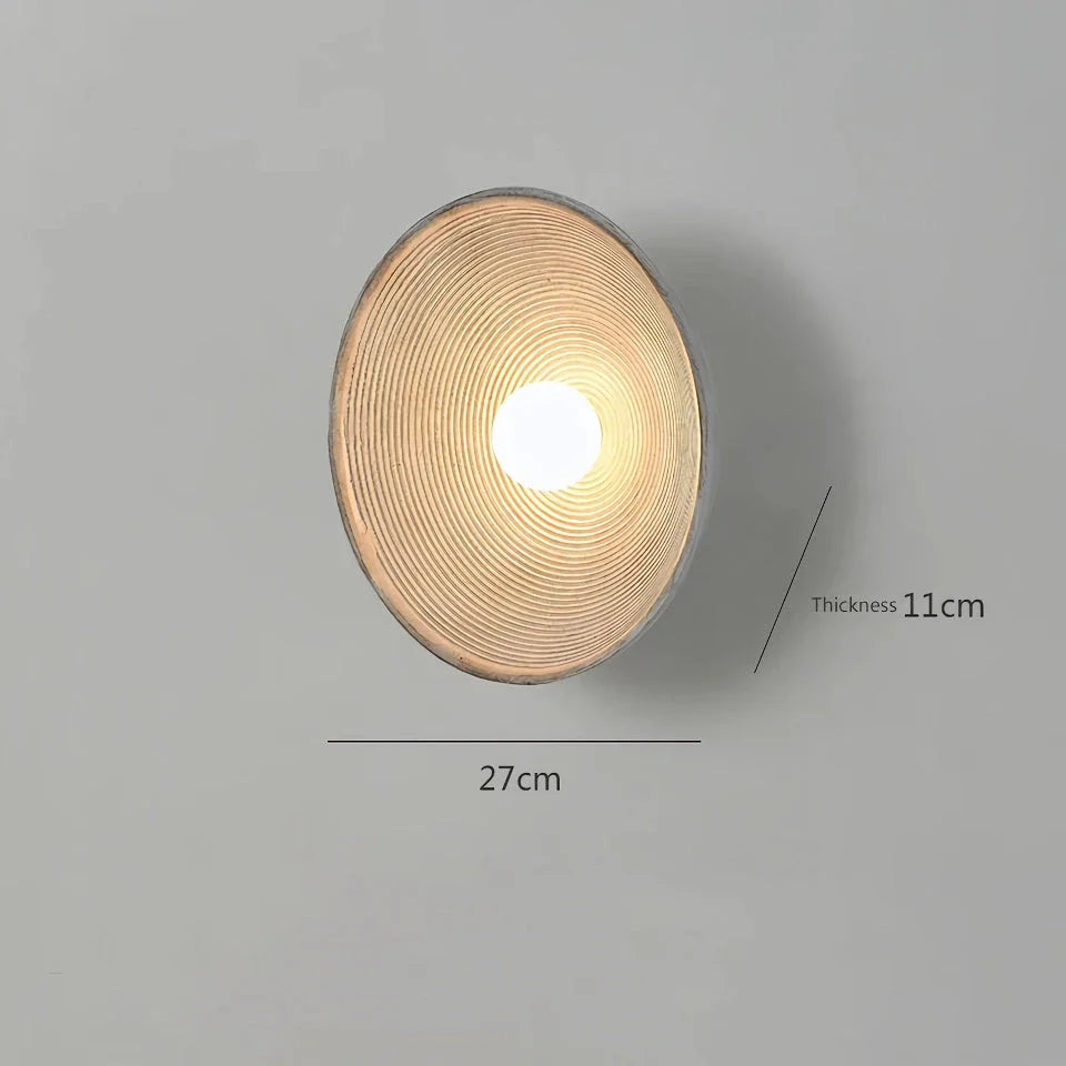 Elegant round wall light fixture with minimalist Wabi Sabi design, providing warm LED illumination for bedrooms and corridors