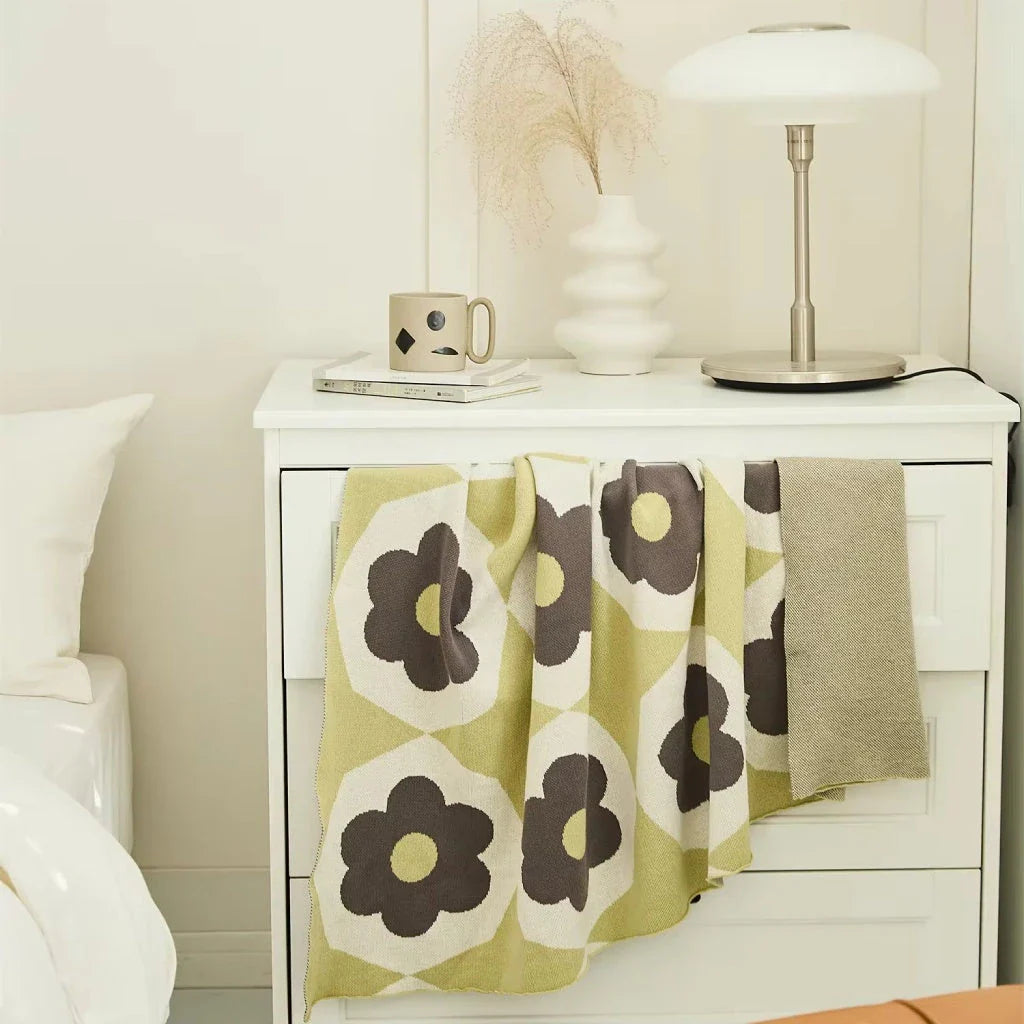 Floral knitted cotton throw blanket in a cosy Matcha Green colour, perfect for British homes and outdoor adventures.