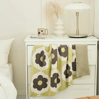 Floral knitted cotton throw blanket in a cosy Matcha Green colour, perfect for British homes and outdoor adventures.