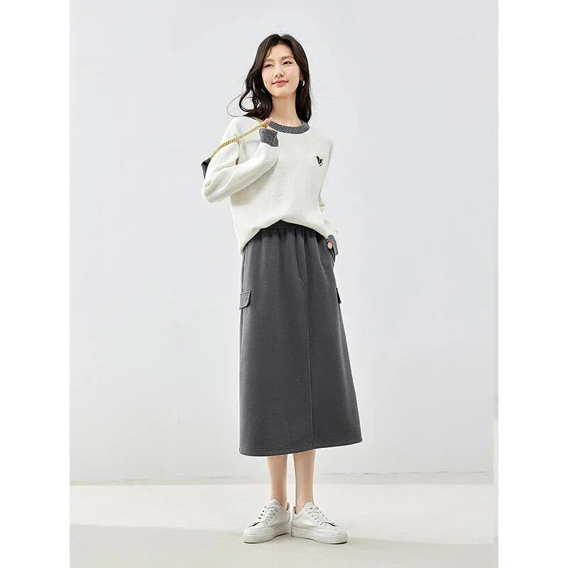 Elegant dark grey midi skirt with subtle sequin detailing, suitable for autumn and winter wear