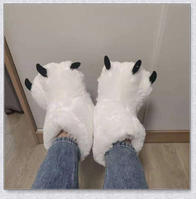 Cosy and whimsical oversized bear paw winter slippers with a plush, fluffy design and non-slip sole for secure indoor wear