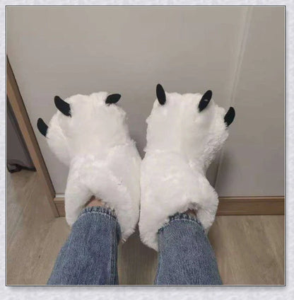 Cosy and whimsical oversized bear paw winter slippers with a plush, fluffy design and non-slip sole for secure indoor wear
