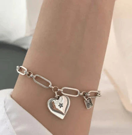 Elegant sterling silver bracelet with a delicate heart charm, a timeless accessory for the modern British woman.