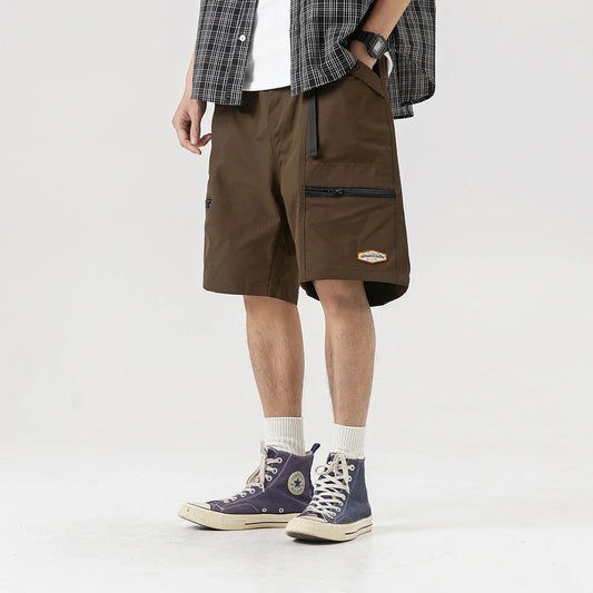 Vintage-inspired workwear shorts with multiple pockets and zippers, offering a stylish and practical solution for everyday wear.