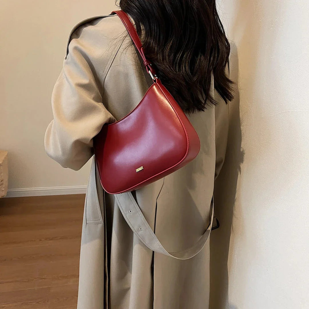Luxury red leather crossbody bag with sleek design and elegant details