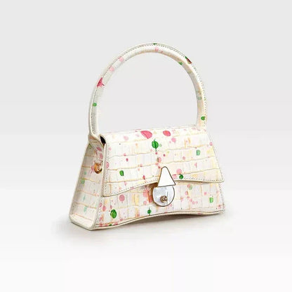 A stylish half-moon shaped genuine leather handbag with a decorative lock, showcasing premium British craftsmanship and timeless elegance.