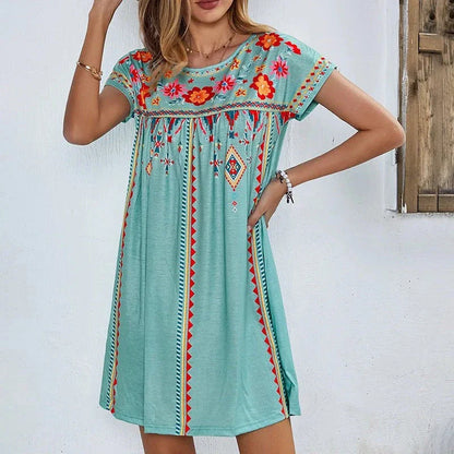 A stylish bohemian-inspired short dress with a geometric pattern, A-line silhouette, and short sleeves, suitable for warm weather