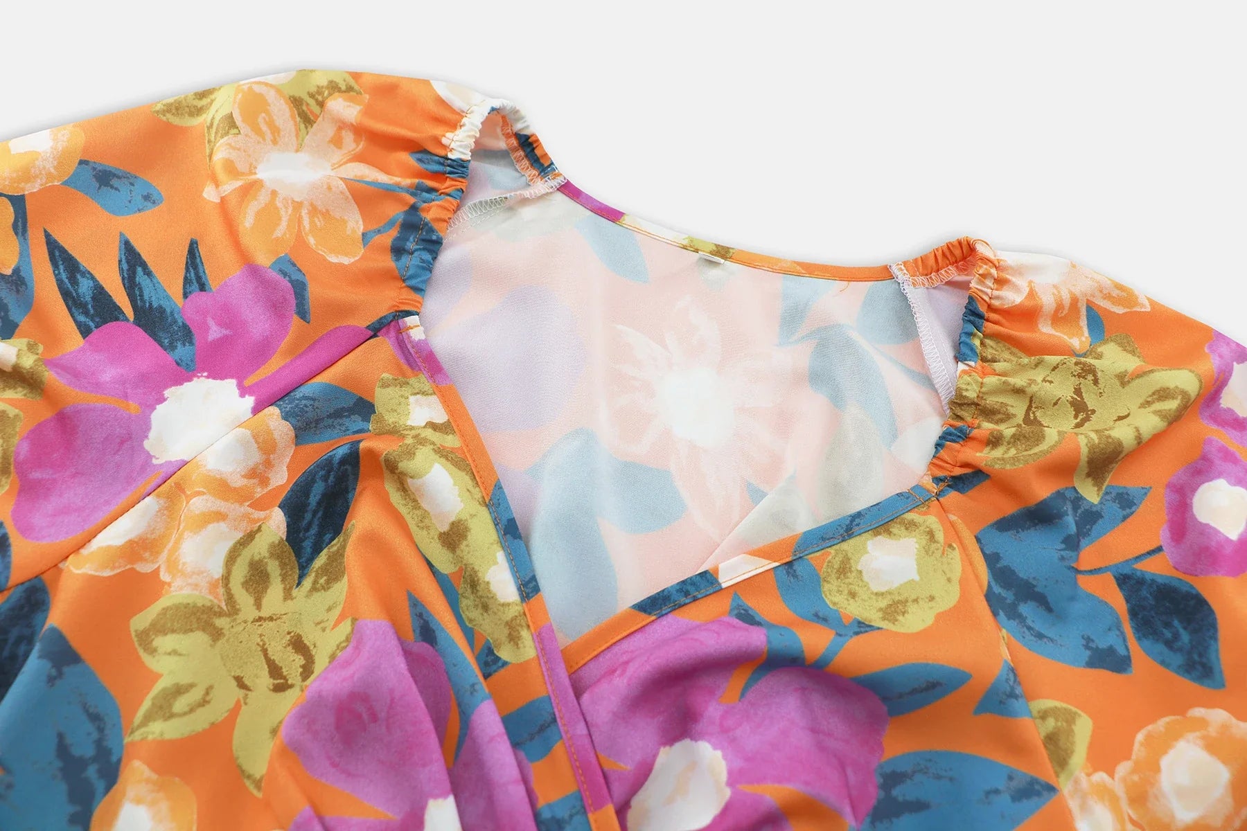 Stylish lantern-sleeve v-neck beach dress in vibrant summer colours, featuring a flattering fit and comfortable stretch fabric