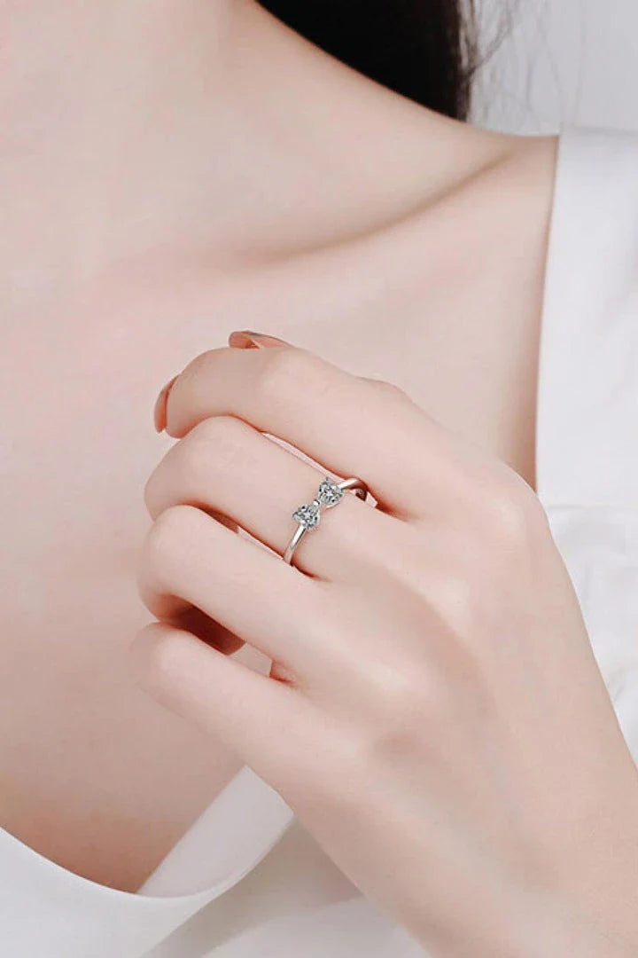 Elegant moissanite and sterling silver bow ring with a radiant, polished finish