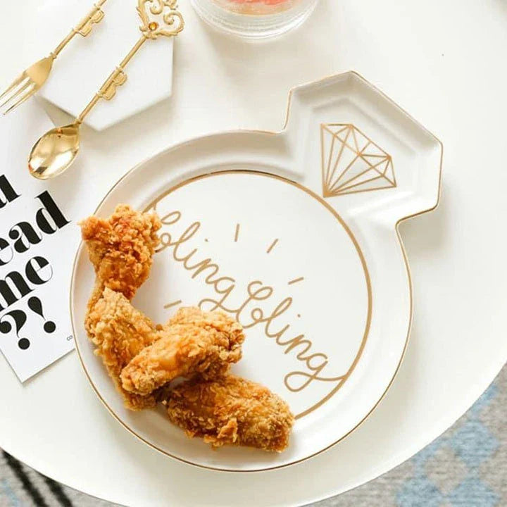 Elegant diamond ring-inspired porcelain dinnerware set with plate, bowl, and cup in a minimalist white colour