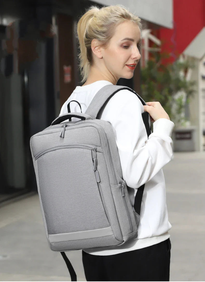 Premium laptop backpack in light grey colour, featuring a sleek and durable polyester design with multiple compartments for organised storage.