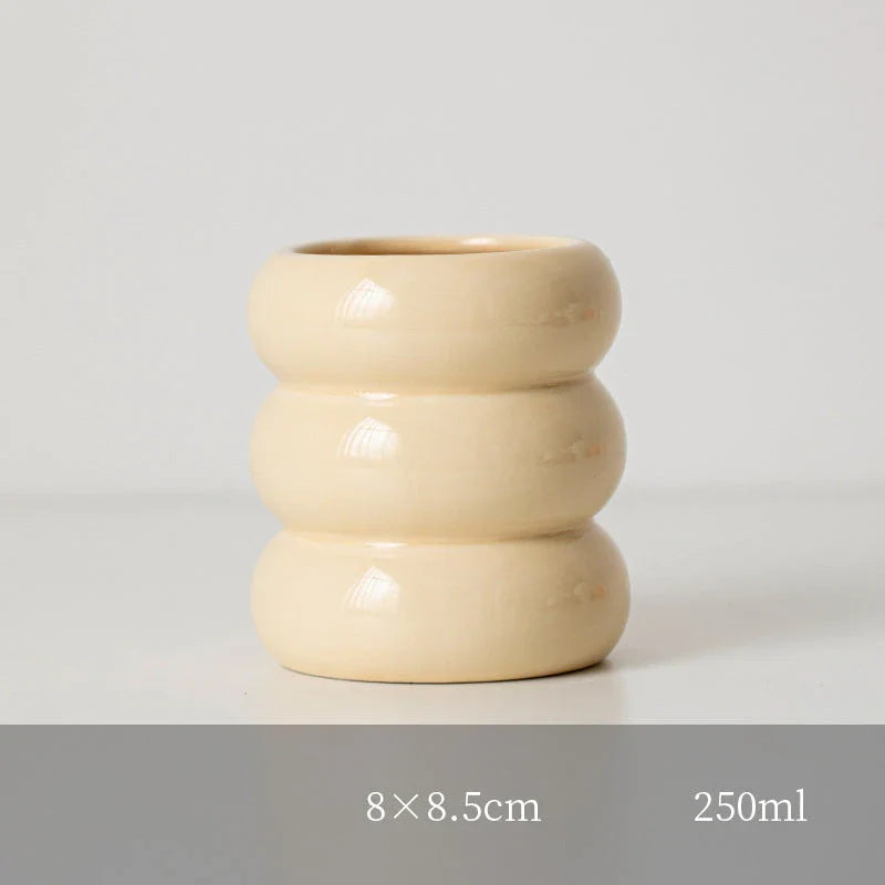 A white ceramic candlestick holder with a minimalist Nordic design, perfect for creating a cosy and sophisticated ambience in any room.