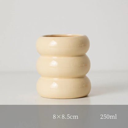 A white ceramic candlestick holder with a minimalist Nordic design, perfect for creating a cosy and sophisticated ambience in any room.
