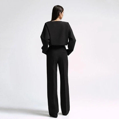 Elegant and sophisticated women's two-piece office suit with long sleeve top and wide-leg pants in a neutral colour palette