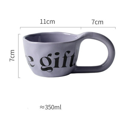 Handcrafted creative alphabet ceramic mug in beige, purple, and khaki colours for hot drinks like coffee and tea