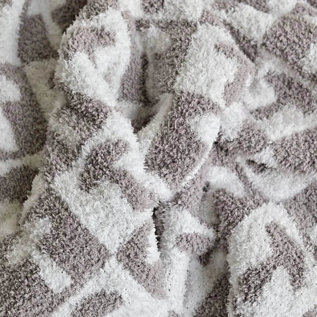 Cosy two-tone checkerboard plaid knitted throw blanket in various colours, including red, blue, grey, and purple