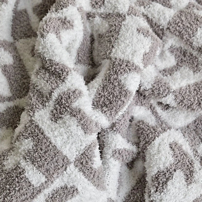 Cosy two-tone checkerboard plaid knitted throw blanket in various colours, including red, blue, grey, and purple