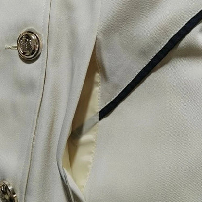 Sleek and sophisticated medium-length commuter coat in black, beige, and blue colours for British professionals