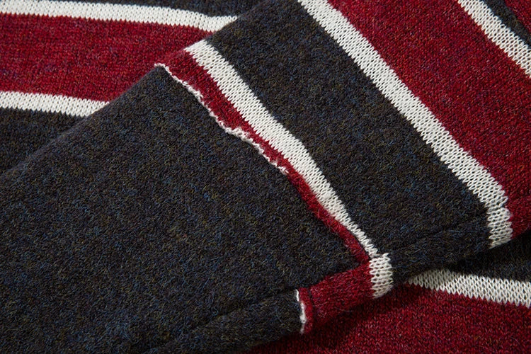 A cosy and stylish jumper featuring a patchwork design with contrasting stripes in a classic British colour palette.