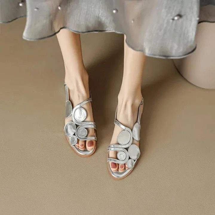 Chic sheepskin round toe sandals with a chunky heel and hollow out design, featuring a secure back strap and a modern, versatile style