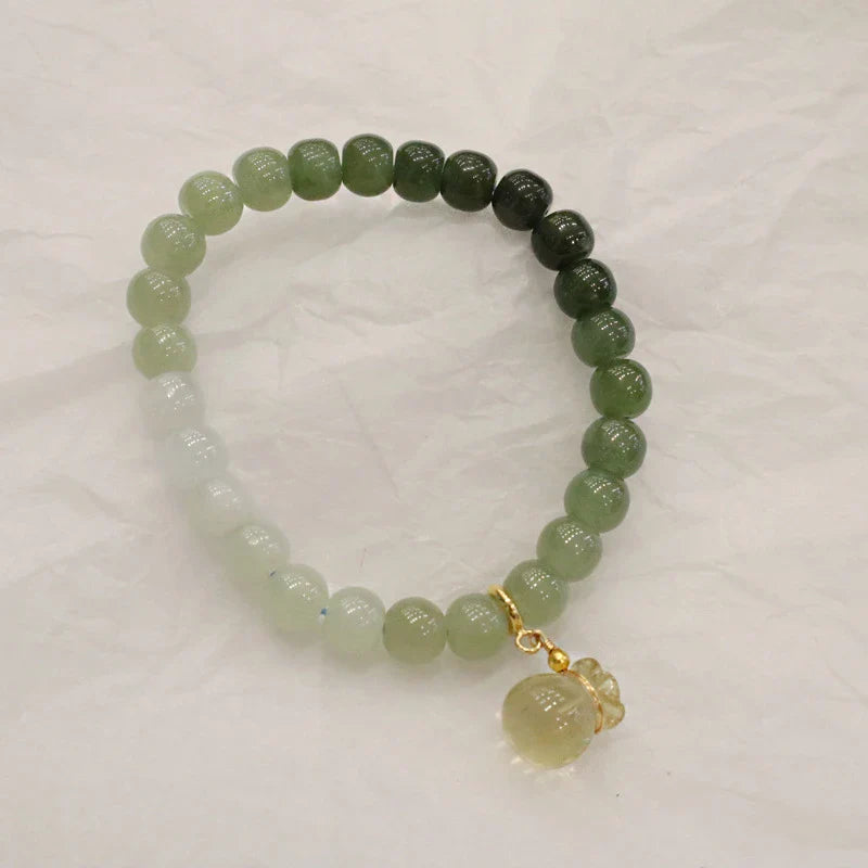 Elegant Hetian jade barrel bead bracelet with gradual colour transition, handcrafted with premium materials for a sophisticated style.