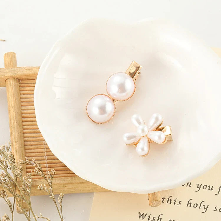 Elegant silver-toned hair clip with a beautiful pearl flower design, a timeless British-inspired accessory