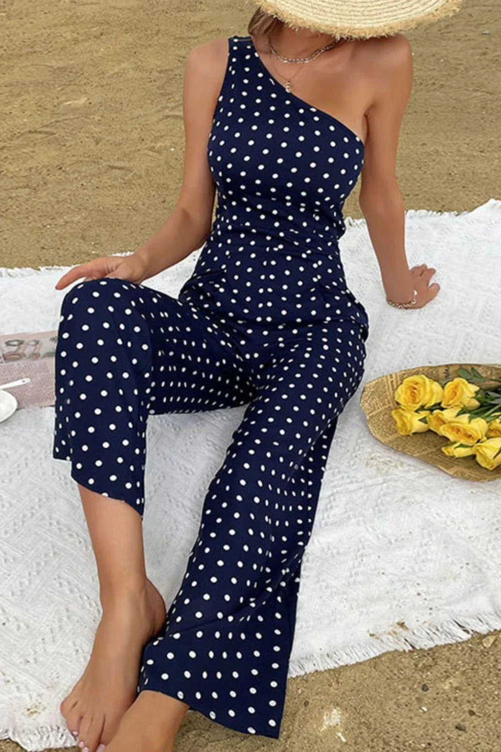 A stylish one-shoulder polka dot jumpsuit with a flattering, figure-hugging silhouette
